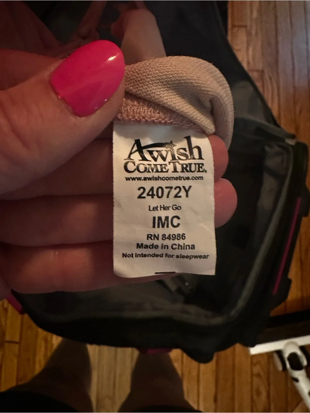 A Wish Come True Pink Nail Polish & Beige Fabric Tag Close-Up